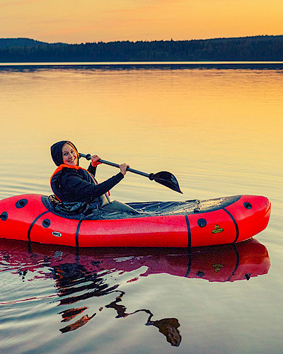 A woman paddling on an inflatable canoe in Lake Pielinen.