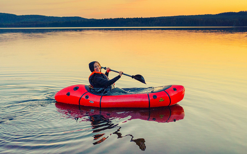 A woman paddling on an inflatable canoe in Lake Pielinen.